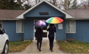 Two women walking into a Nature Centre